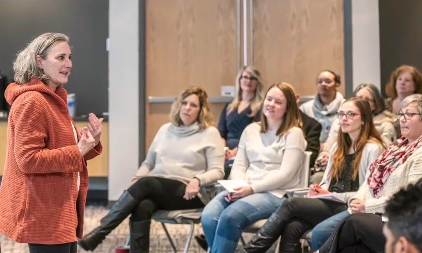 Photo of a woman addressing an audience.